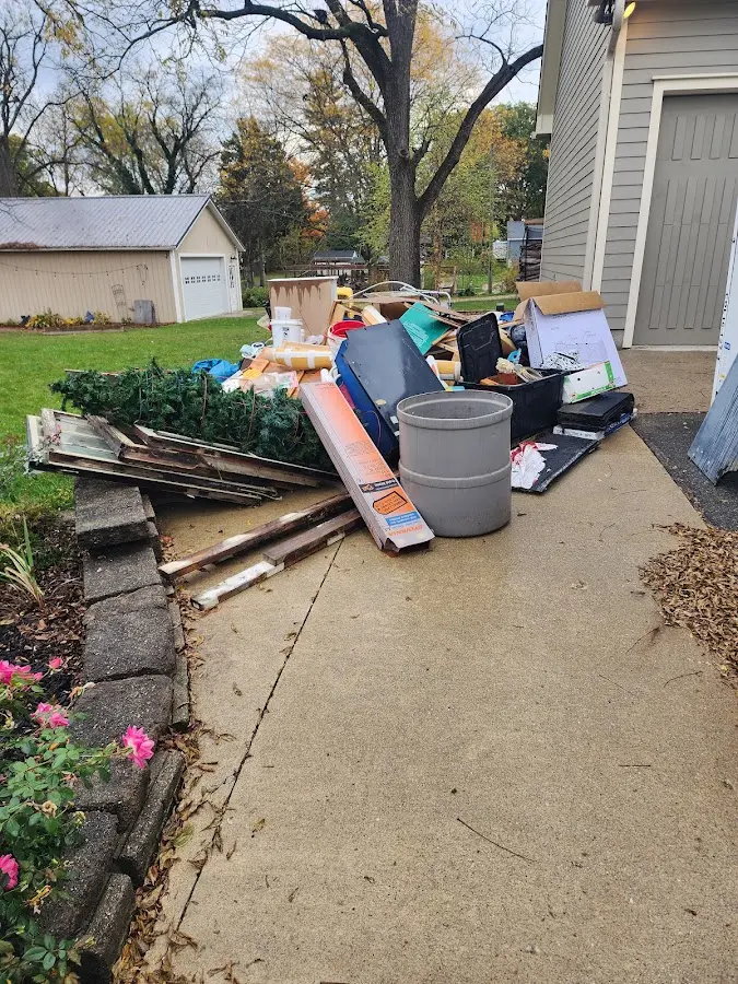 Dumpster being loaded with debris for 12 Yard Dumpster Rental in Bellview